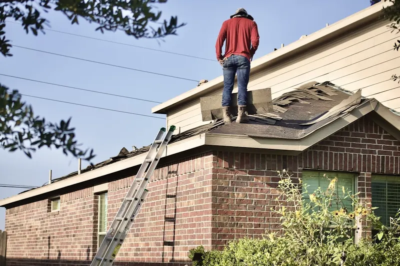 Professional roofer working on a residential roof in Camp Washington